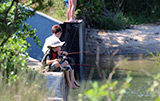 Two boys at Second Bridge patiently fishing for snappers
