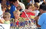 Frank Adipietro, Lions Club president, talking as the kids check out the trophies