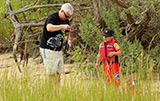Father showing his son how to fish at Second Bridge